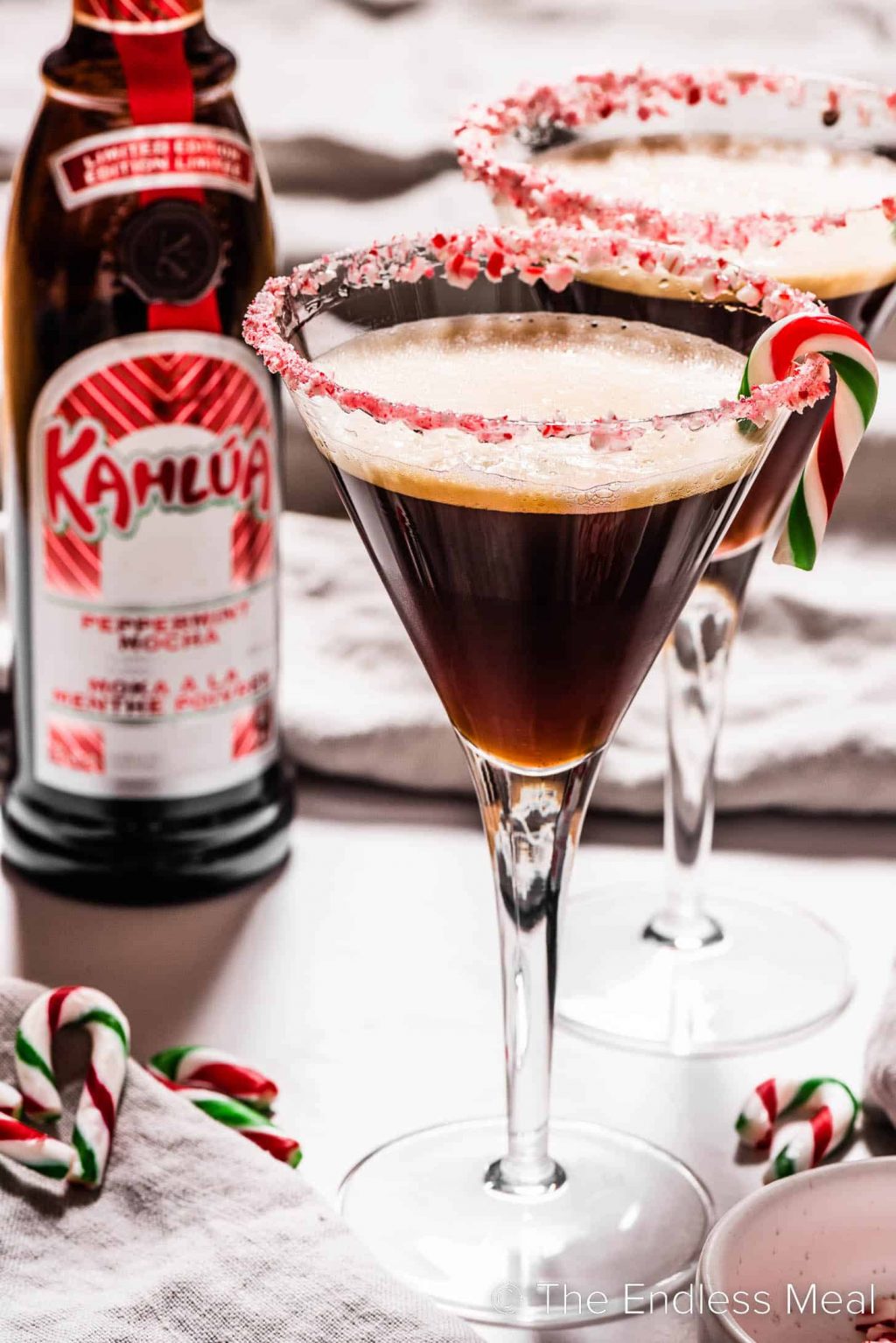 A Peppermint Espresso Martini with a Kahlua bottle in the background