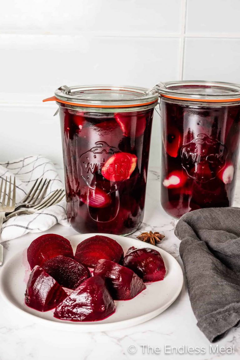 Pickled Beets and Onions in canning jars on a kitchen counter.