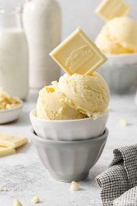 A bowl of White Chocolate Ice Cream topped with a square of white chocolate