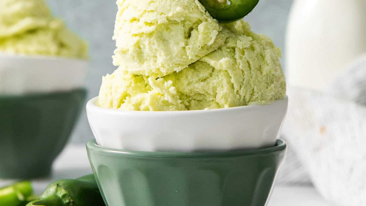 Jalapeño Ice Cream in a green dessert bowl topped with jalapeno slices